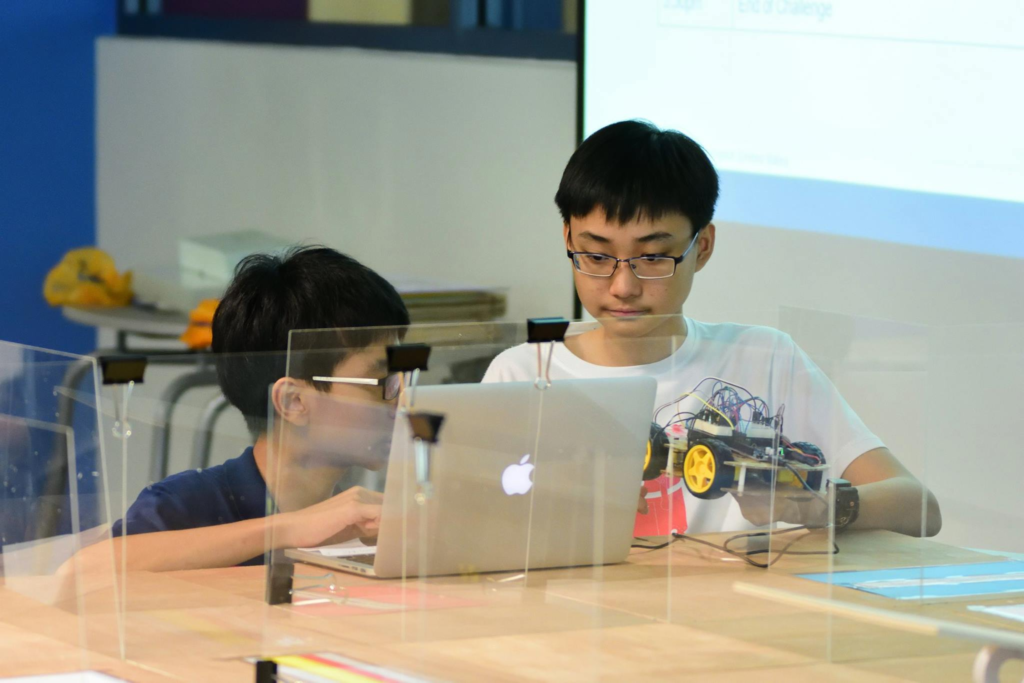Students working on Arduino-based robots during the inaugural Arduino Challenge at APYRC, held at Temasek Polytechnic.
