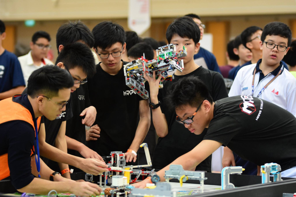 Maris Stella High School students assembling LEGO robots during FLL Singapore 2018 at Canadian International School.
