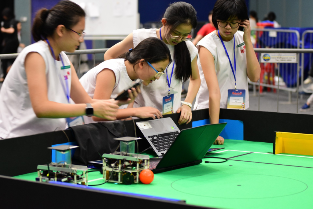 Nanyang Girls’ High School students collaborating on soccer robots during RoboCup Singapore Open 2019 at Science Centre Singapore.