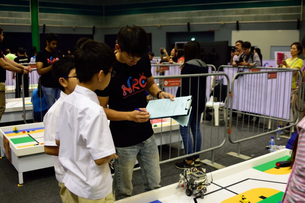 Students presenting their LEGO robot to a judge during NJRC 2017 at Science Centre Singapore.