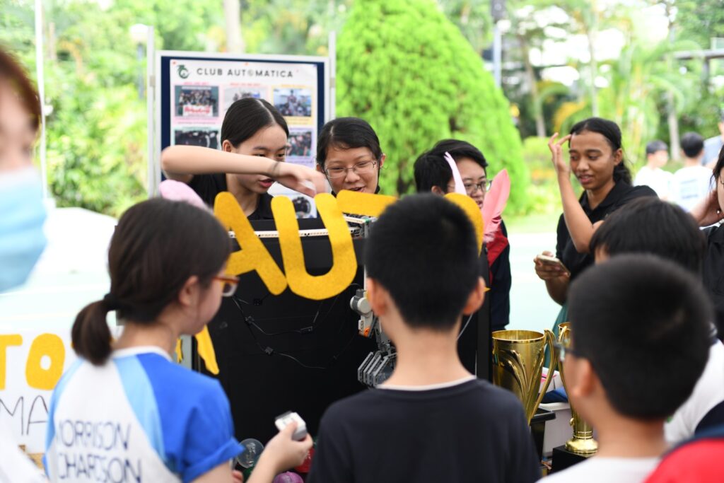 Club Automatica booth with claw machine at Raffles Institution Open House 2023