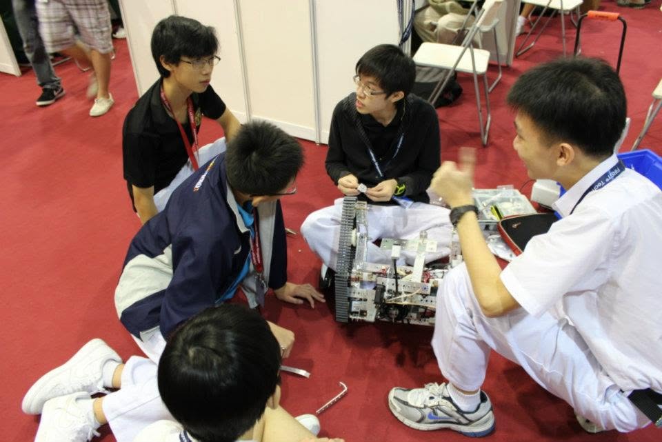RI Infocomm Club team working on robot at FTC 2011
